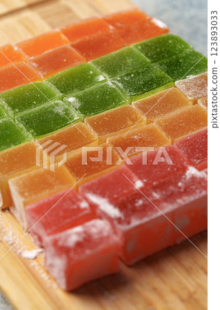 Colorful candy cubes arranged on a wooden board with a variety of fruity flavors and vibrant colors Colorful candy cubes arranged on a wooden board with a variety of fruity flavors and vibrant colors 123893033