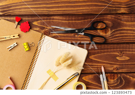 Crafting materials arranged on a wooden table for creative projects and DIY activities 123893473
