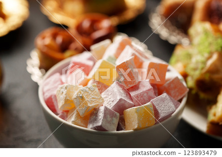 Colorful Turkish delight arranged in a bowl at a festive gathering in a warm setting Colorful Turkish delight arranged in a bowl at a festive gathering in a warm setting 123893479