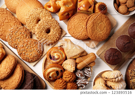 Sweet assortment of various baked treats arranged beautifully on a wooden surface Sweet assortment of various baked treats arranged beautifully on a wooden surface 123893516
