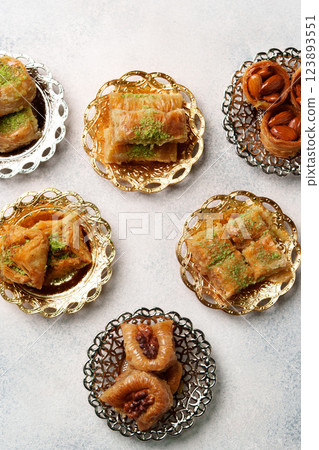 Assorted sweet desserts displayed on decorative plates in a cozy setting during festive celebration Assorted sweet desserts displayed on decorative plates in a cozy setting during festive celebration 123893551