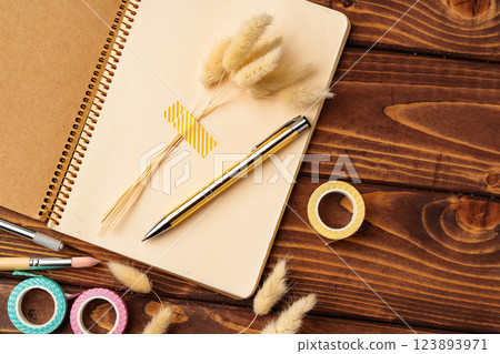 Creative workspace featuring stationery and natural elements for personal organization and inspiration Creative workspace featuring stationery and natural elements for personal organization and inspiration 123893971