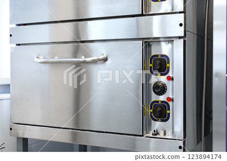 Industrial baking oven equipped for commercial kitchen use in a modern baking facility Industrial baking oven equipped for commercial kitchen use in a modern baking facility 123894174