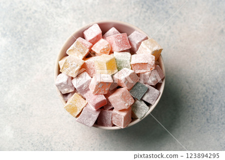Colorful sugar-dusted candy cubes arranged in a bowl ready for a sweet treat at a gathering Colorful sugar-dusted candy cubes arranged in a bowl ready for a sweet treat at a gathering 123894295