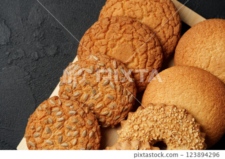 Freshly baked cookies arranged on a wooden tray in a cozy kitchen setting Freshly baked cookies arranged on a wooden tray in a cozy kitchen setting 123894296