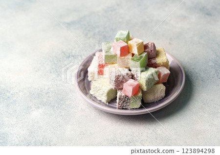 Colorful assortment of traditional confectionery displayed on a plate in a soft light setting 123894298