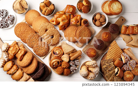 Assortment of baked goods displayed on a wooden surface with various styles and flavors Assortment of baked goods displayed on a wooden surface with various styles and flavors 123894345