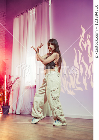 Dynamic dance performance in modern studio with vibrant lighting and creative shadows Dynamic dance performance in modern studio with vibrant lighting and creative shadows 123894510