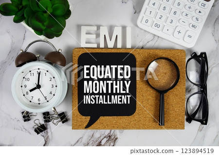 EMI - Equated Monthly Installment acronym with calculator, alarm clock and magnifying glass, Business and Financial concept background 123894519