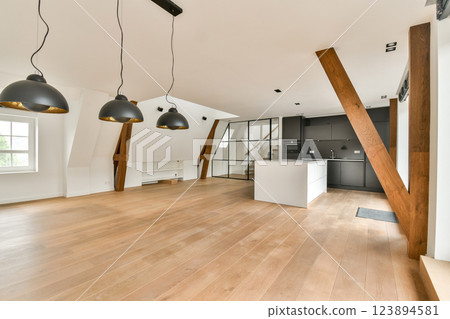 Stylish modern kitchen and living area featuring open layout, wooden beams, and sleek appliances. Natural light enhances the contemporary design aesthetic. Stylish modern kitchen and living area featuring open layout, wooden beams, and sleek appliances. Natural light enhances the contemporary design aesthetic. 123894581