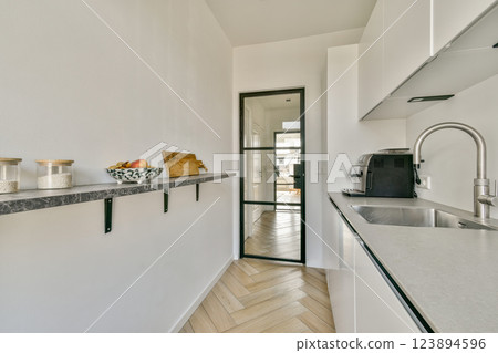 A sleek, modern kitchen featuring clean lines, minimalist decor, and a light color palette. Natural light flows through the open space, creating a bright atmosphere. A sleek, modern kitchen featuring clean lines, minimalist decor, and a light color palette. Natural light flows through the open space, creating a bright atmosphere. 123894596