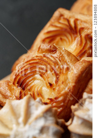 Freshly baked pastries showcasing intricate layers and textures, perfect for any dessert lover Freshly baked pastries showcasing intricate layers and textures, perfect for any dessert lover 123894808