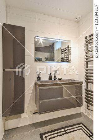A sleek, modern bathroom featuring minimalist cabinetry, stylish fixtures, and contemporary mirror design that enhances the space's elegance. A sleek, modern bathroom featuring minimalist cabinetry, stylish fixtures, and contemporary mirror design that enhances the space's elegance. 123894817