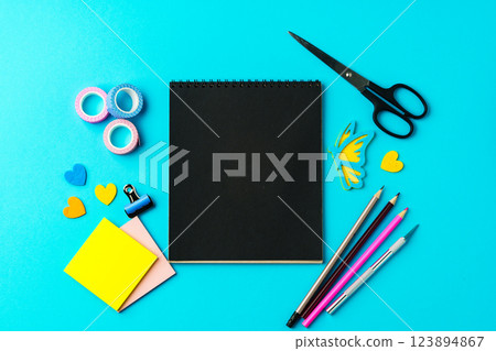 Creative workspace with colorful stationery arranged on a bright blue background for art projects Creative workspace with colorful stationery arranged on a bright blue background for art projects 123894867