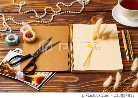 Creative workspace with scrapbook materials and decorative elements during the day 123894932