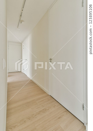A spacious and bright hallway featuring clean lines and minimalistic design elements, reflecting contemporary interior decor trends and aesthetics. A spacious and bright hallway featuring clean lines and minimalistic design elements, reflecting contemporary interior decor trends and aesthetics. 123895106