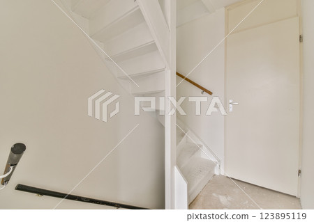 A sleek modern staircase leading to an upper floor, featuring minimalist design and a clean aesthetic ideal for contemporary spaces. A sleek modern staircase leading to an upper floor, featuring minimalist design and a clean aesthetic ideal for contemporary spaces. 123895119
