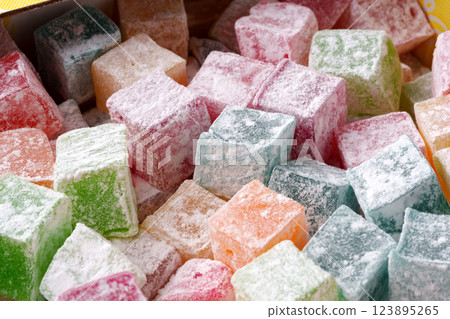 Colorful cubes of traditional Turkish delight arranged in a box ready to be enjoyed at a festive market Colorful cubes of traditional Turkish delight arranged in a box ready to be enjoyed at a festive market 123895265