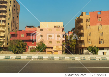 Vibrant buildings along a busy street in Cairo showcasing local architecture under a clear sky Vibrant buildings along a busy street in Cairo showcasing local architecture under a clear sky 123895401