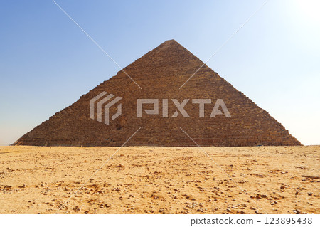 Majestic view of the Great Pyramid of Giza under a clear blue sky during midday 123895438