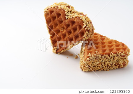 Heart-shaped waffles coated with nuts add a sweet touch to any dessert platter at a cozy cafe Heart-shaped waffles coated with nuts add a sweet touch to any dessert platter at a cozy cafe 123895560