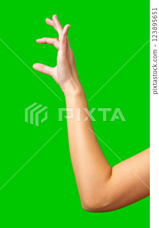 Person performing a hand gesture against a bright green background during a creative working session 123895651