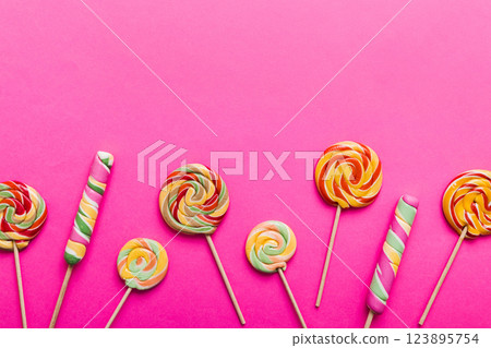 Set of colorful lollipops on colored background. Summer concept. Party Happy Birthday or Minimalist Concept Set of colorful lollipops on colored background. Summer concept. Party Happy Birthday or Minimalist Concept 123895754