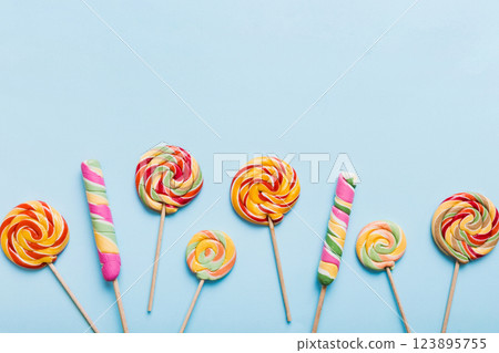 Set of colorful lollipops on colored background. Summer concept. Party Happy Birthday or Minimalist Concept Set of colorful lollipops on colored background. Summer concept. Party Happy Birthday or Minimalist Concept 123895755