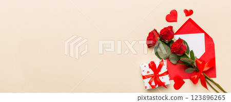 Valentine day composition with Envelope, rose flower and Red heart on table. Top view, flat lay. Holiday concept 123896265