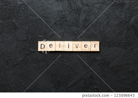 deliver word written on wood block. deliver text on table, concept deliver word written on wood block. deliver text on table, concept 123896643