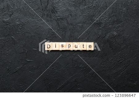 dispute word written on wood block. dispute text on table, concept 123896647