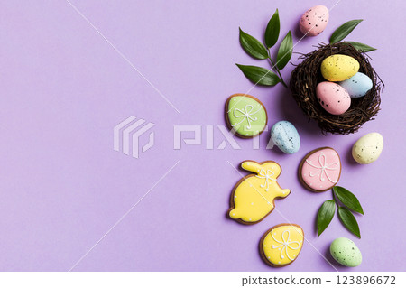 Colorful easter eggs in nest on table background with copy space top view Colorful easter eggs in nest on table background with copy space top view 123896672
