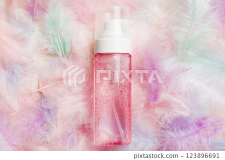 Spa cosmetic product, cream bottle, branding mock up, top view with feathers background. Flat lay 123896691