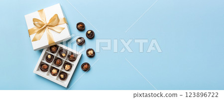 White box with chocolates candies and golden tape. top view with copy space 123896722