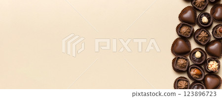 Different kinds of chocolates on colored table close-up. Top View and Flat Lay with copy space 123896723