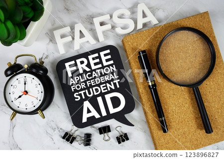 FAFSA - Free Application for Federal Student Aid acronym with alarm clock and magnifying glass, business concept background 123896827