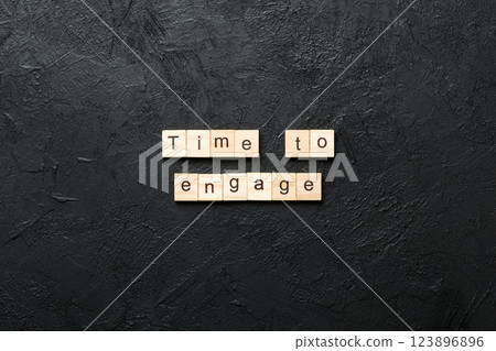 Time to engage word written on wood block. Time to engage text on table, concept 123896896