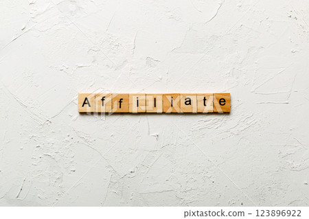 AFFILIATE word written on wood block. AFFILIATE text on cement table for your desing, concept 123896922