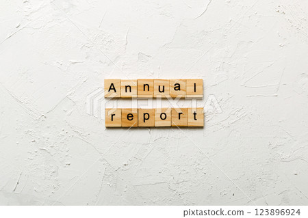 Annual report word written on wood block. Annual report text on cement table for your desing, concept 123896924