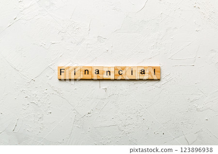 financial word written on wood block. financial text on table, concept financial word written on wood block. financial text on table, concept 123896938