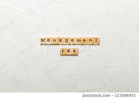management fee word written on wood block. management fee text on cement table for your desing, concept 123896955