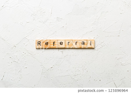 Referral word written on wood block. Referral text on cement table for your desing, Top view concept Referral word written on wood block. Referral text on cement table for your desing, Top view concept 123896964