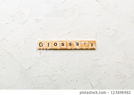 glossary word written on wood block. glossary text on table, concept glossary word written on wood block. glossary text on table, concept 123896982