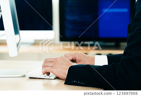 Hands of a man working on a computer Hands of a man working on a computer 123897008