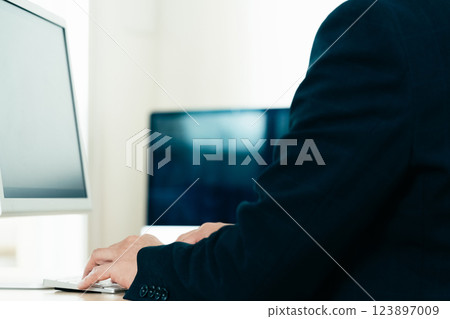 Hands of a man working on a computer Hands of a man working on a computer 123897009