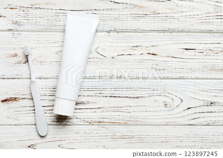 toothpaste and toothbrush top view with copy space on colored background. Flat lay. Dental hygiene. Oral care products on light background. Body care concept 123897245