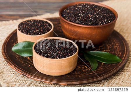 quinoa seeds in bowl on colored background. Healthy kinwa in small bowl. Healthy superfood quinoa seeds in bowl on colored background. Healthy kinwa in small bowl. Healthy superfood 123897259