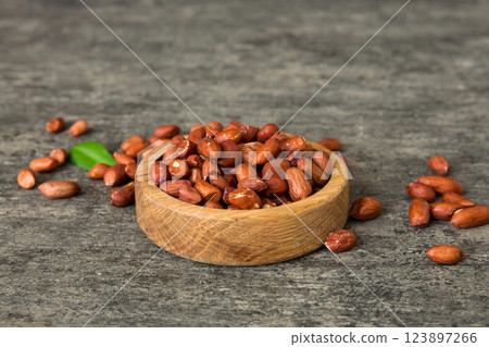 Fresh healthy peanuts in bowl on colored table background. Top view Healthy eating bertholletia concept. Super foods Fresh healthy peanuts in bowl on colored table background. Top view Healthy eating bertholletia concept. Super foods 123897266