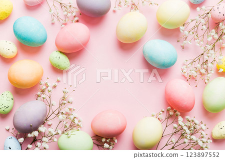 Happy Easter composition. Easter eggs on colored table with gypsophila. Natural dyed colorful eggs background top view with copy space 123897552
