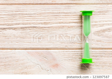 hourglass on the table, sand clock as time passing concept for business deadline, copy space 123897587